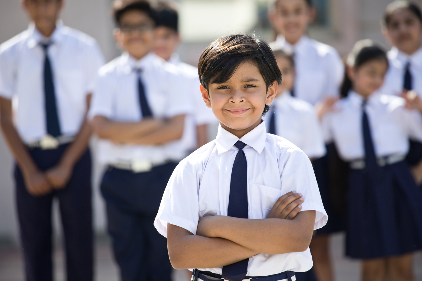 Portrait of confident boy in school uniform